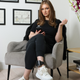 Delvey in her home wearing an ankle monitor.